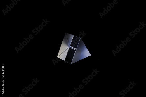 Glass prism on a black background close-up