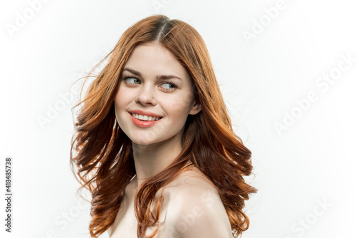 attractive red-haired woman with bare shoulders glamor cosmetics 