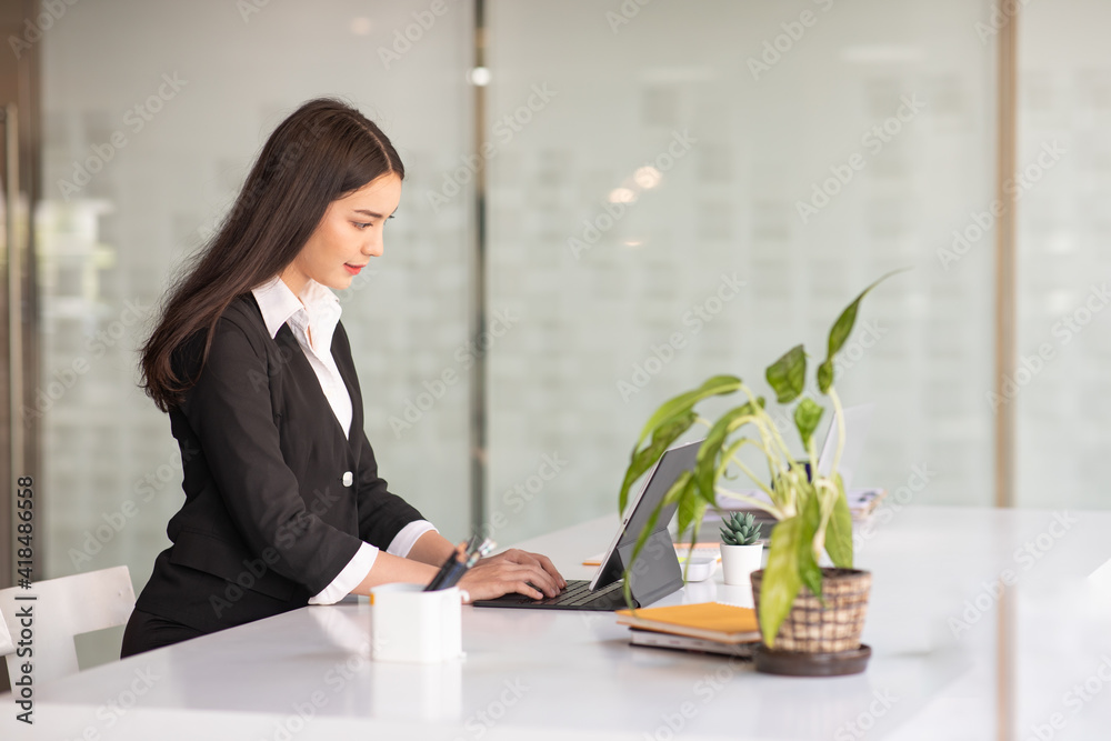 Portrait of Young Business Female Working with a laptop at home office. Portrait of Young Business Female Working with a laptop at home office.