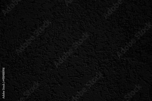 texture of dark wall covered with volumetric plaster, space for text, space for copy