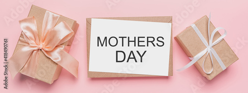 Gifts with note letter on isolated pink background, love and valentine concept with text mothers Day