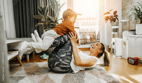 Canvastavla Beautiful young mother practicing fitness exercising and yoga together with her adorable little son