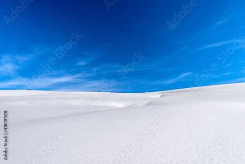 Closeup of a winter landscape with powder snow on blue sky with clouds. Lessinia Plateau (Altopiano della Lessinia), Regional Natural Park, Verona Province, Veneto, Italy, Europe. © Alberto Masnovo