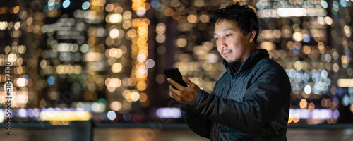 Photography Banner and web page or cover template of Asian man using smart mobile phone with