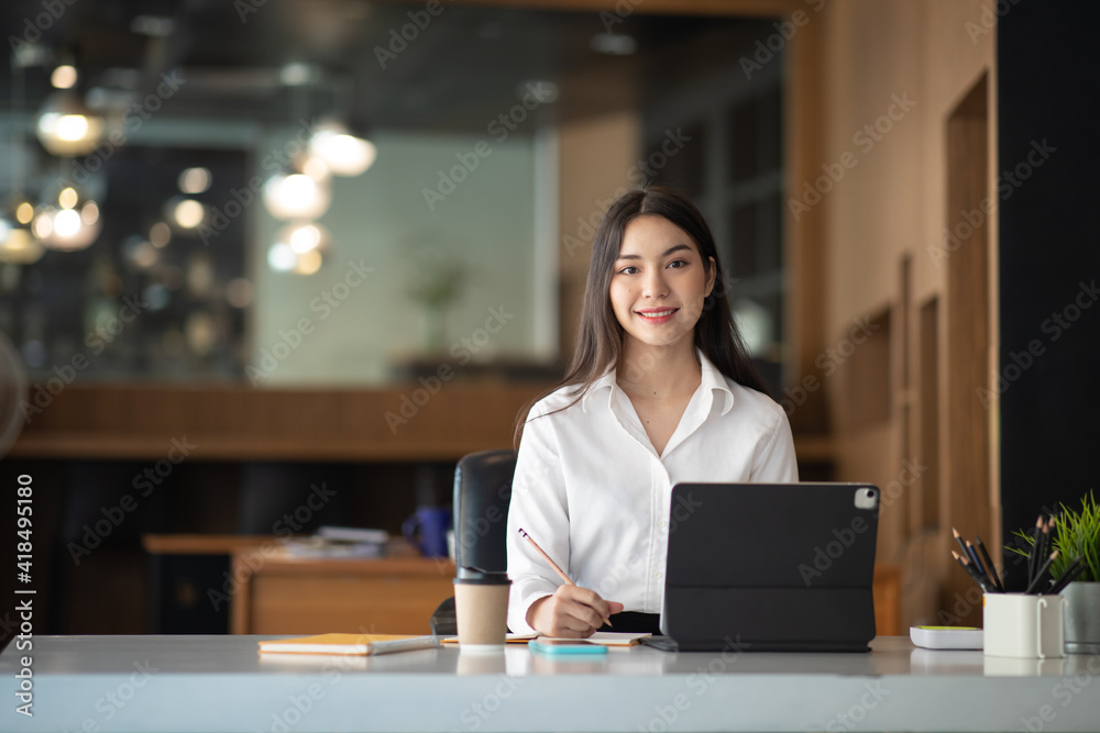 Shot of a asian young business Female working on laptop in her workstation. Shot of a asian young business Female working on laptop in her workstation.