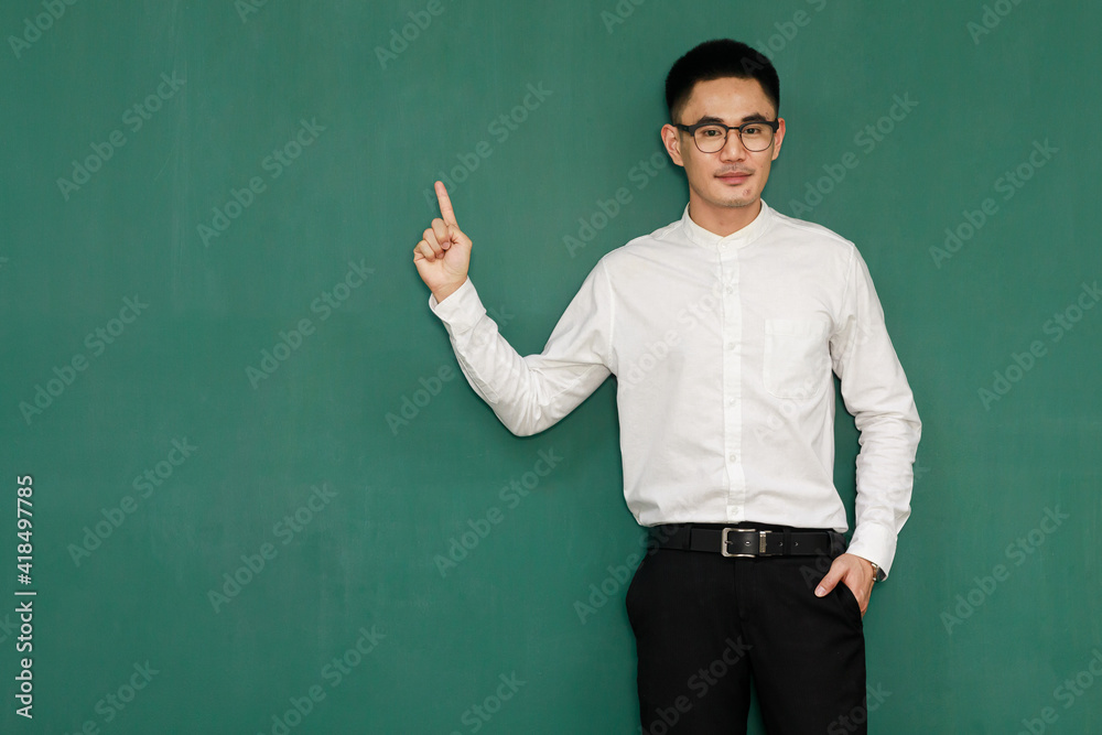 Portrait of young and handsome Asian man wearing eyeglasses and casual business clothes, white shirt and black trousers, pose in gestures of advertising and present somethings with self-confidence