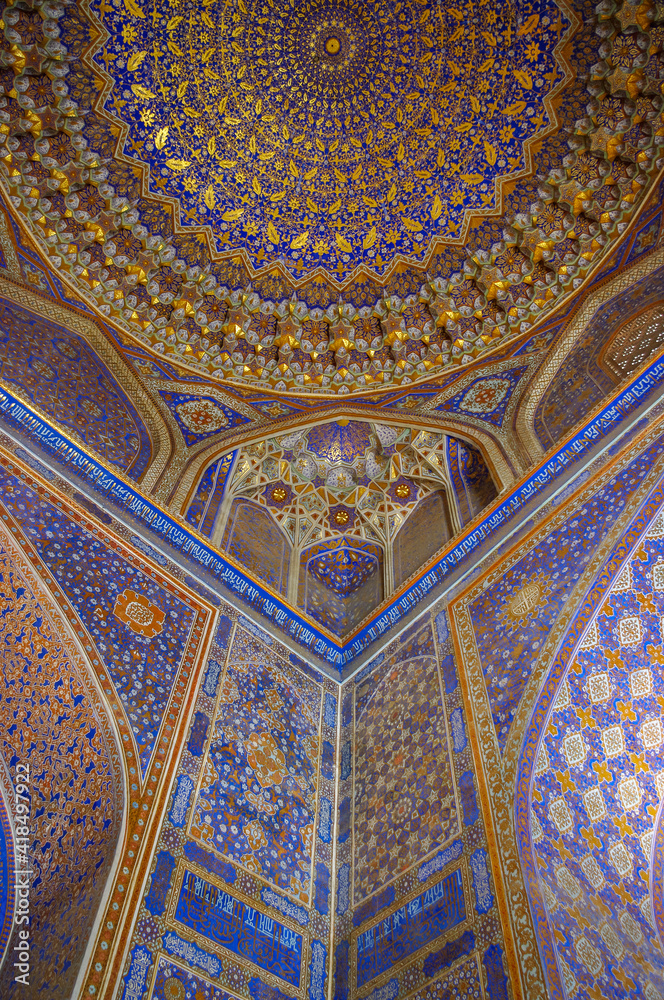 Beautiful gold and blue interior of ancient Tilya Kori madrassa on Registan square in UNESCO listed Samarkand, Uzbekistan