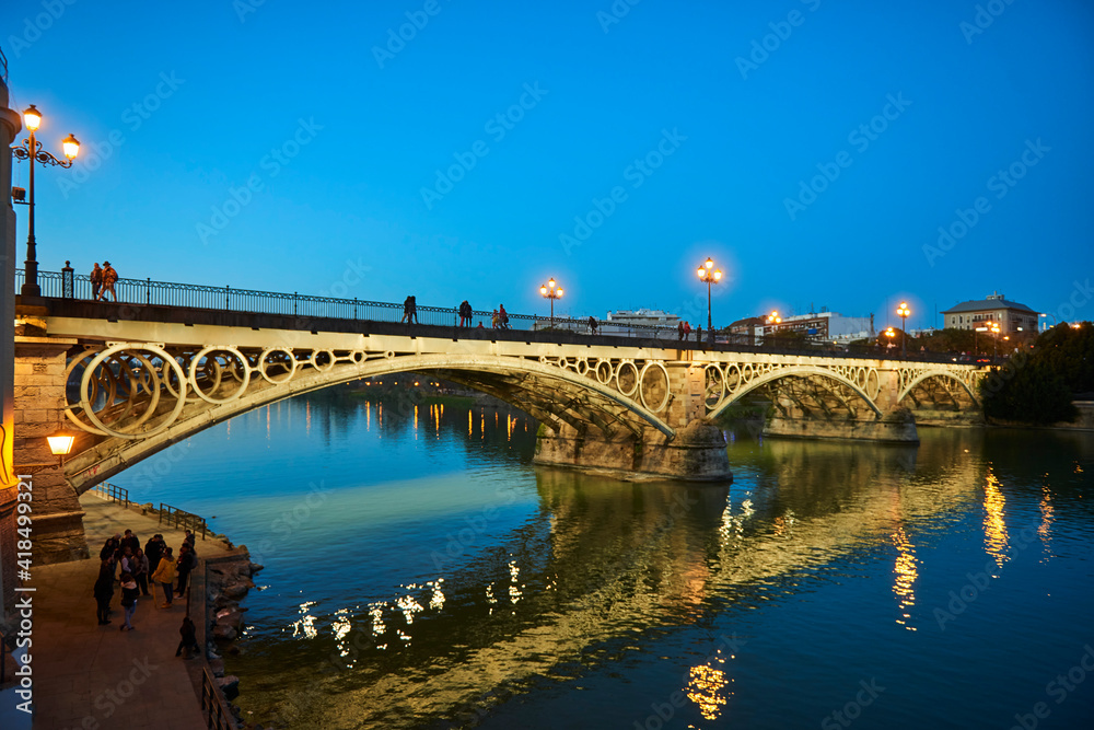 Isabel II bridge or Triana bridge, in Guadalquivir river at Evening,Sevilla,Andalucía,Spain, Europe.