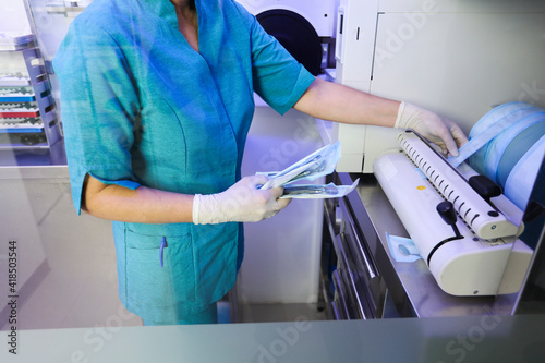 partial view of nurse with hospital material in hands, surgical material disinfection, dental hospital background