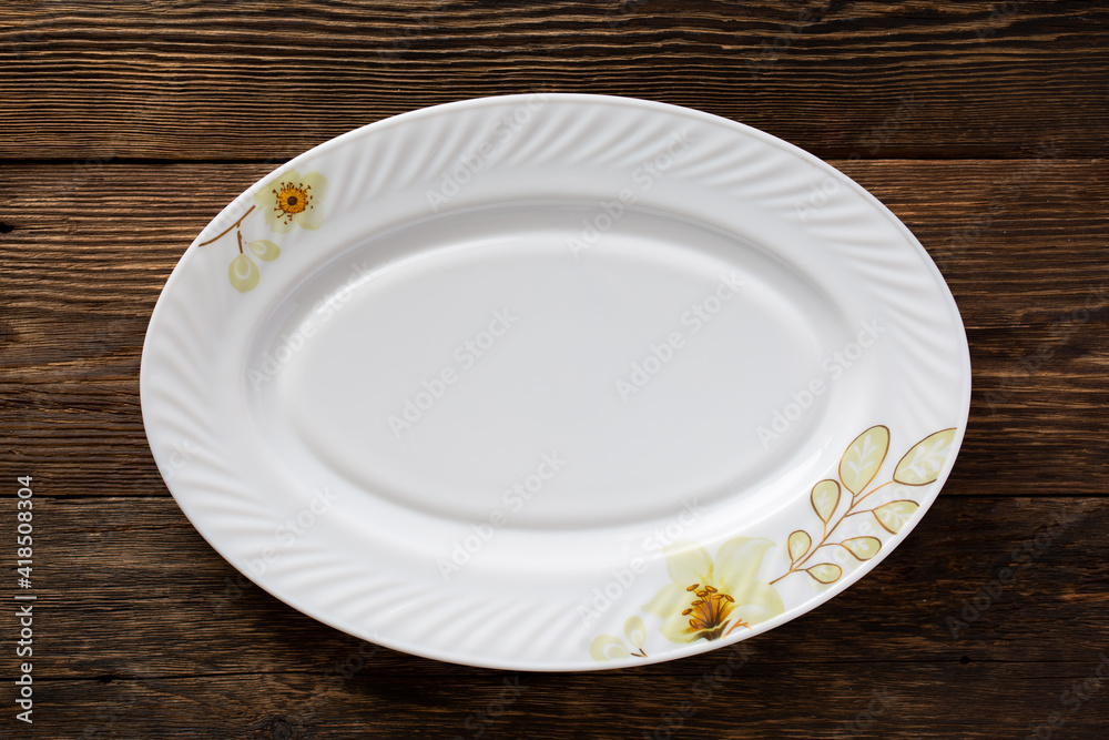 White empty dish on wooden background White empty dish on wooden background