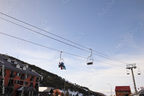 Chairlifts in a winter resort. Palandoken mountains, Erzurum in turkey. two person sitting on Chairlifts. Winter temperature in Erzurum can reach -50 degrees Celsius