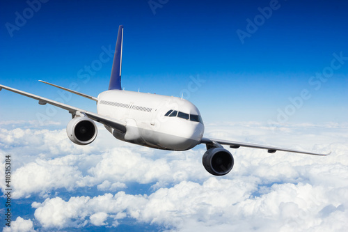 Passenger jetplane flying above clouds