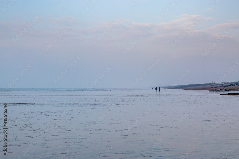 Distant Figures Walking on the Beach at Low Tide, at Shoreham-by-Sea