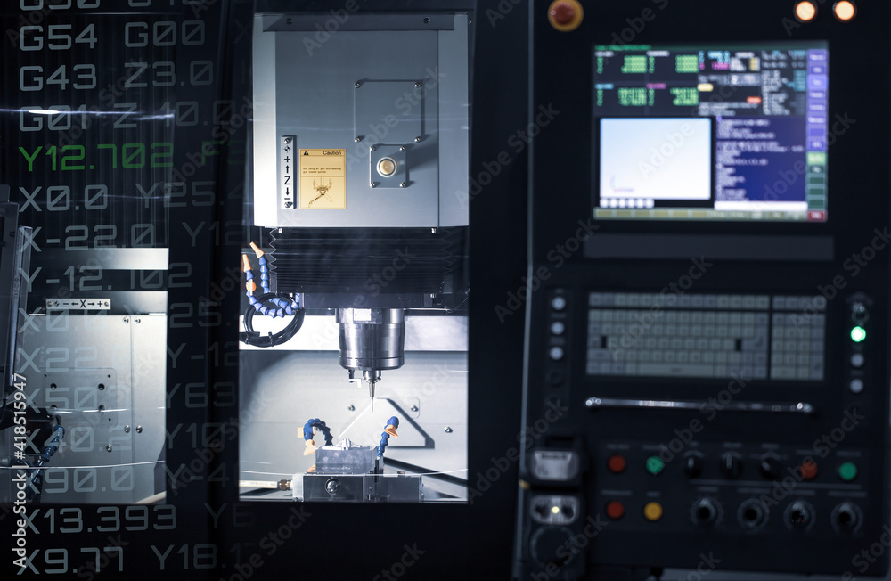 CNC milling machine cutting automotive part. CNC programming code ...