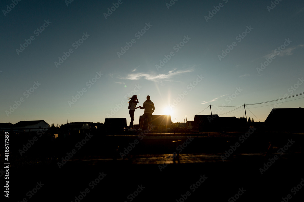 Silhouettes of a couple in love against the setting sun. lifestyle. Copy space