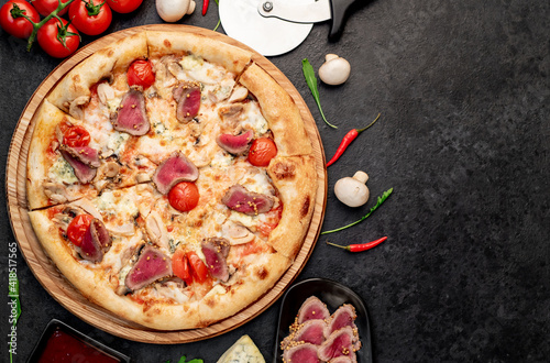 delicious meat pizza on a stone background  with copy space for your text