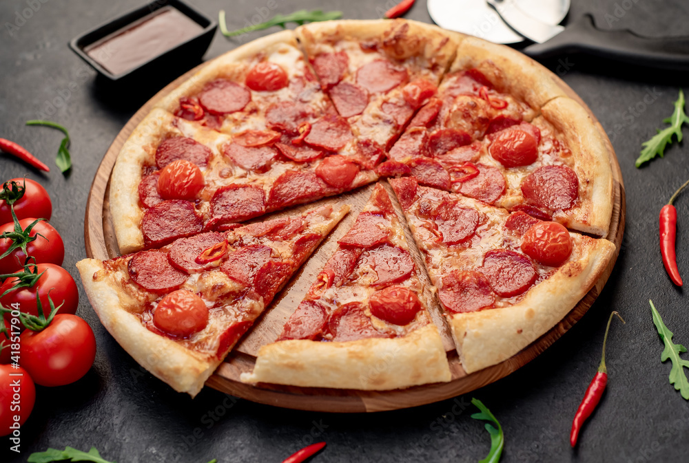 pepperoni pizza with ingredients on stone background pepperoni pizza with ingredients on stone background