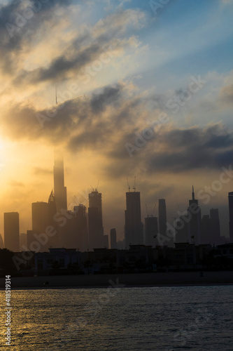 Dubai  UAE - 03.06.2021 Dubai public beach with city skyline on background.Sunrise hour. Outdoor