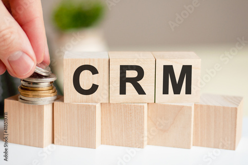 CRM letters written on wooden toy blocks, business concept