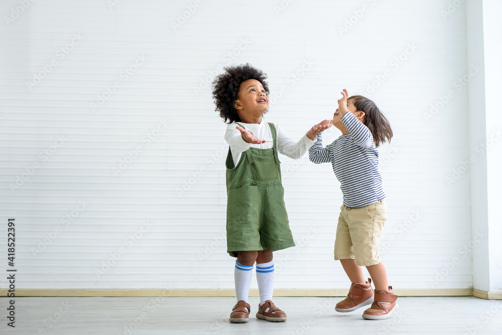 The children jumped for joy, chasing the money that had fallen from the sky above The children jumped for joy, chasing the money that had fallen from the sky above