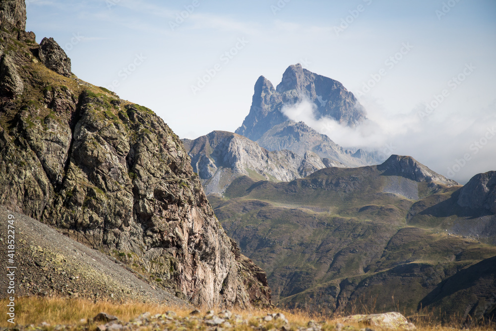Spectacular image of a beautiful mountain in the Pyrenees with clouds all around