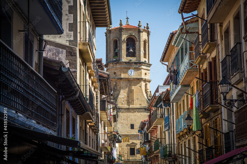Guetaria, Spain - August 12 2018: Main street view with the cathedral in the background