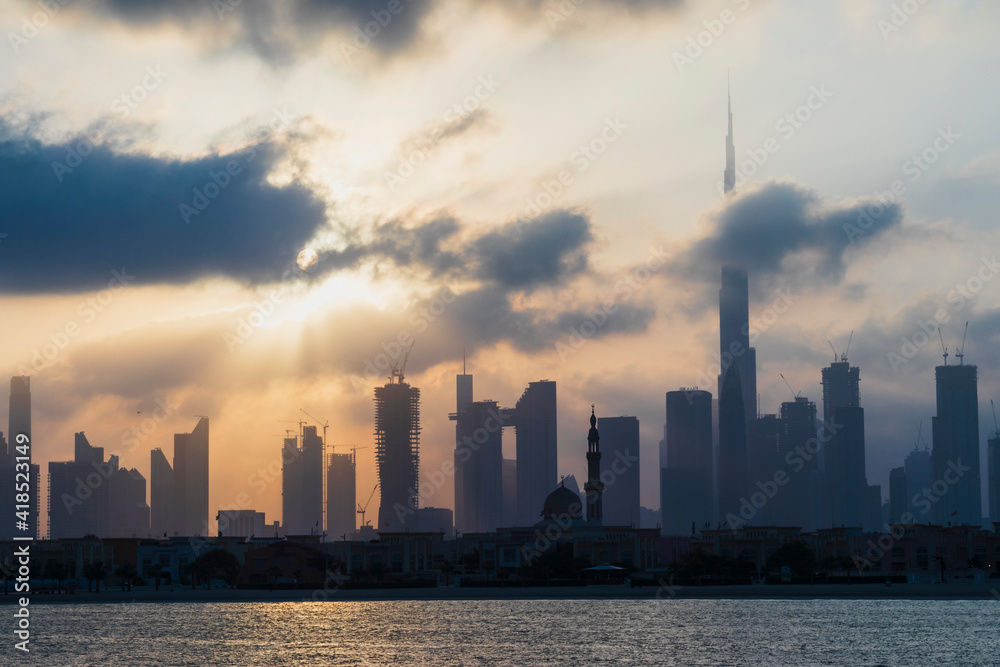 Dubai, UAE - 03.06.2021 Dubai public beach with city skyline on background.Sunrise hour. Outdoor