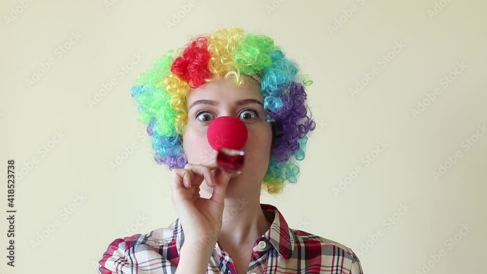 Woman in funny wig fooling around and having fun, celebrating the first of April. High quality FullHD footage