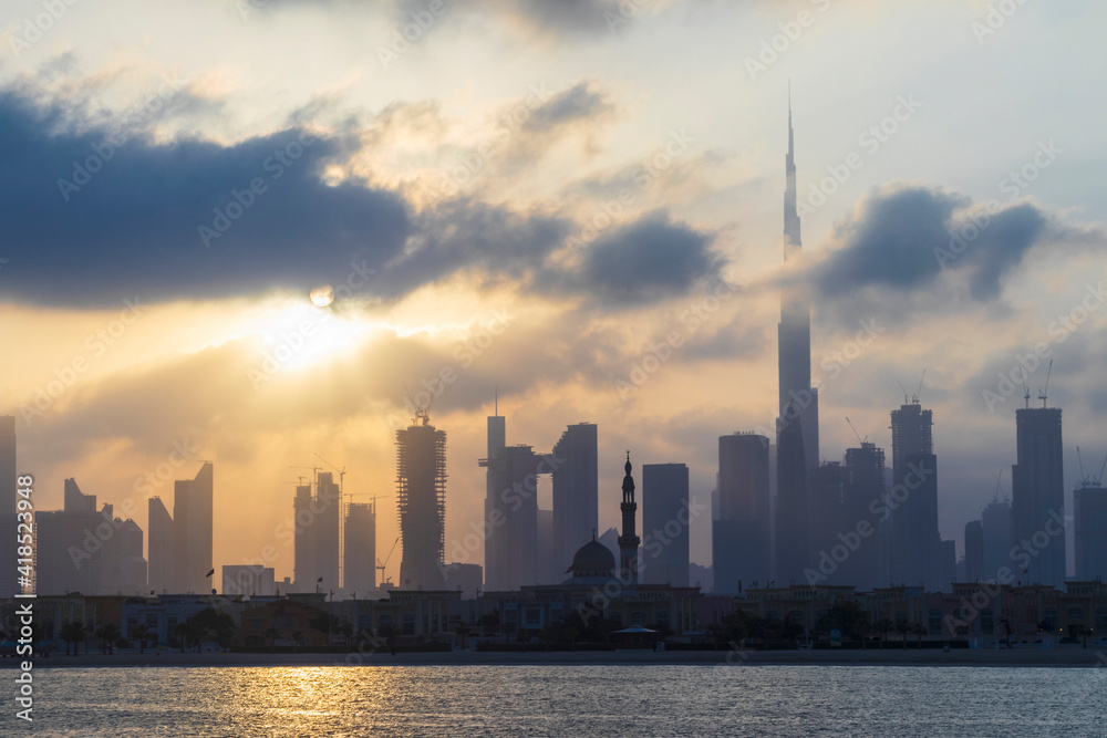 Obraz premium Dubai, UAE - 03.06.2021 Dubai public beach with city skyline on background.Sunrise hour. Outdoor