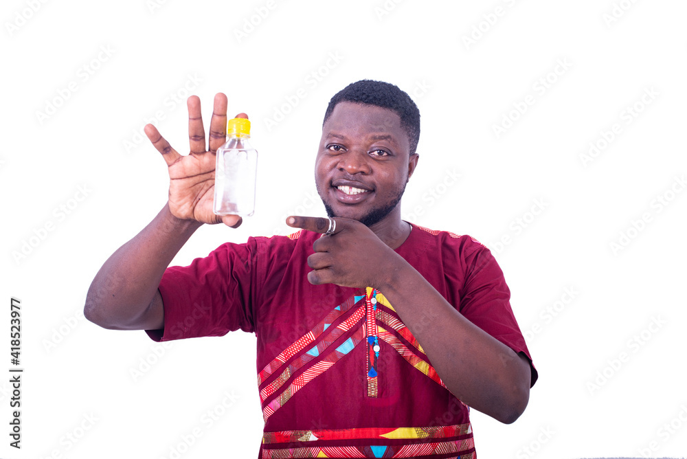 handsome young man pointing finger on bottle. handsome young man pointing finger on bottle.