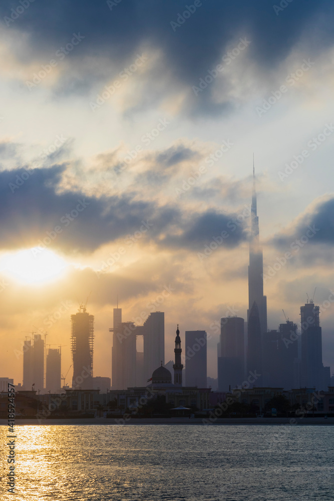 Fototapeta premium Dubai, UAE - 03.06.2021 Dubai public beach with city skyline on background.Sunrise hour. Outdoor