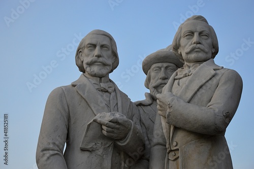 Sculptural group of Slovak revolutionary politicians and writers from 19th century, J. M. Hurban, M. M. Hodza and J. Francisci-Rimavský. Location Modra, western Slovakia. Blue skies in background. 