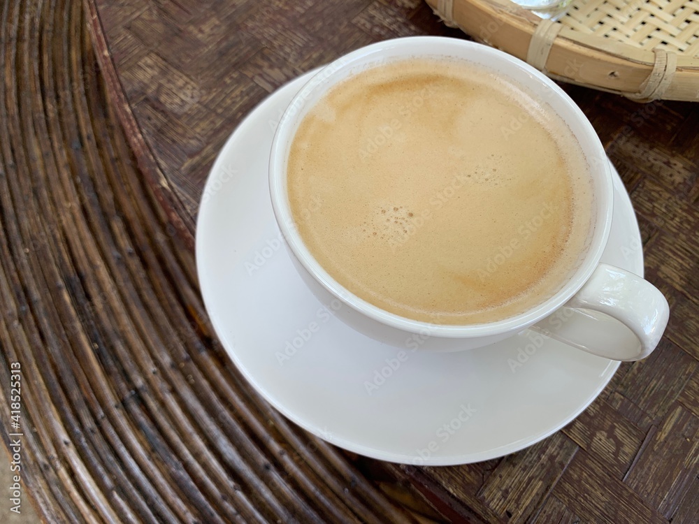 Hot americano with creama on white glass in a local setting Hot americano with creama on white glass in a local setting