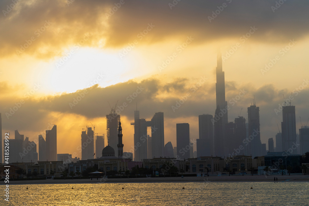 Dubai, UAE - 03.06.2021 Dubai public beach with city skyline on background.Sunrise hour. Outdoor