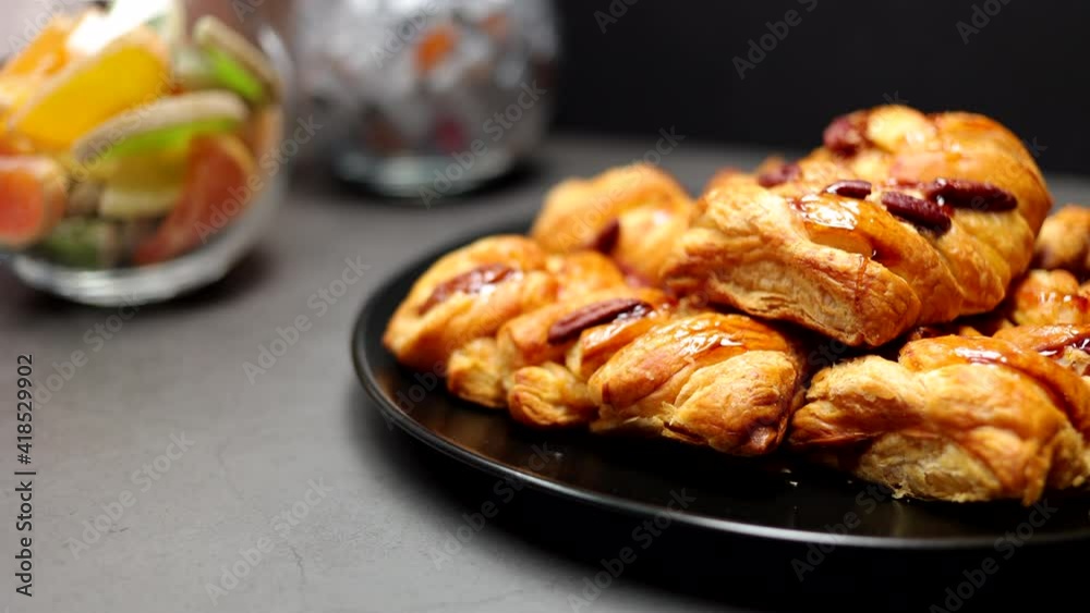 Pastries With Roasted Pecan And Maple Syrup On The Black Plate On The Black Breakfast Table. Panning Dolly Slider Shot. Pastries With Roasted Pecan And Maple Syrup On The Black Plate On The Black Breakfast Table. Panning Dolly Slider Shot.
