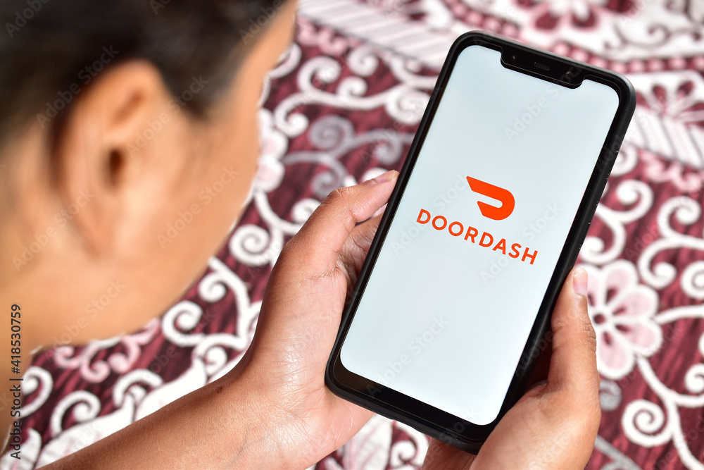 Girl using doordash application on smartphone online food delivery app