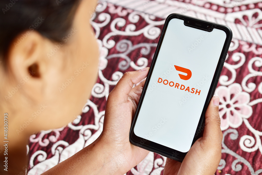 Using doordash application on smartphone, doordash food delivery app on