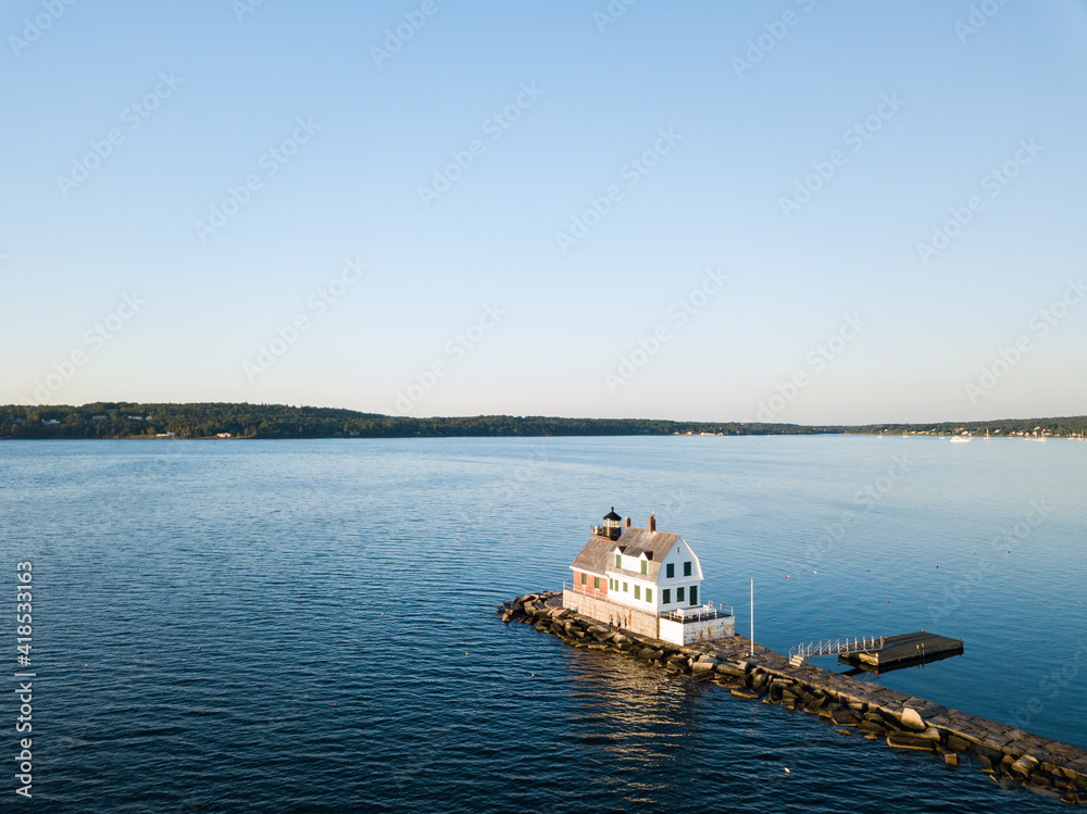 The Rockland Breakwater Lighthouse at the end of the mile long breakwater in Rockland Maine as viewed via an aerial drone image in the mornng light
