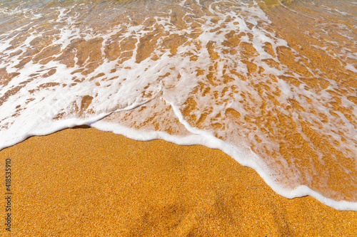 Fototapeta Naklejka Na Ścianę i Meble -  Soft sea wave on a sandy beach without people on a sunny day