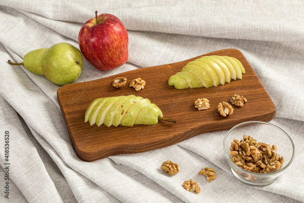 Fresh sliced pear on a wooden cutting board