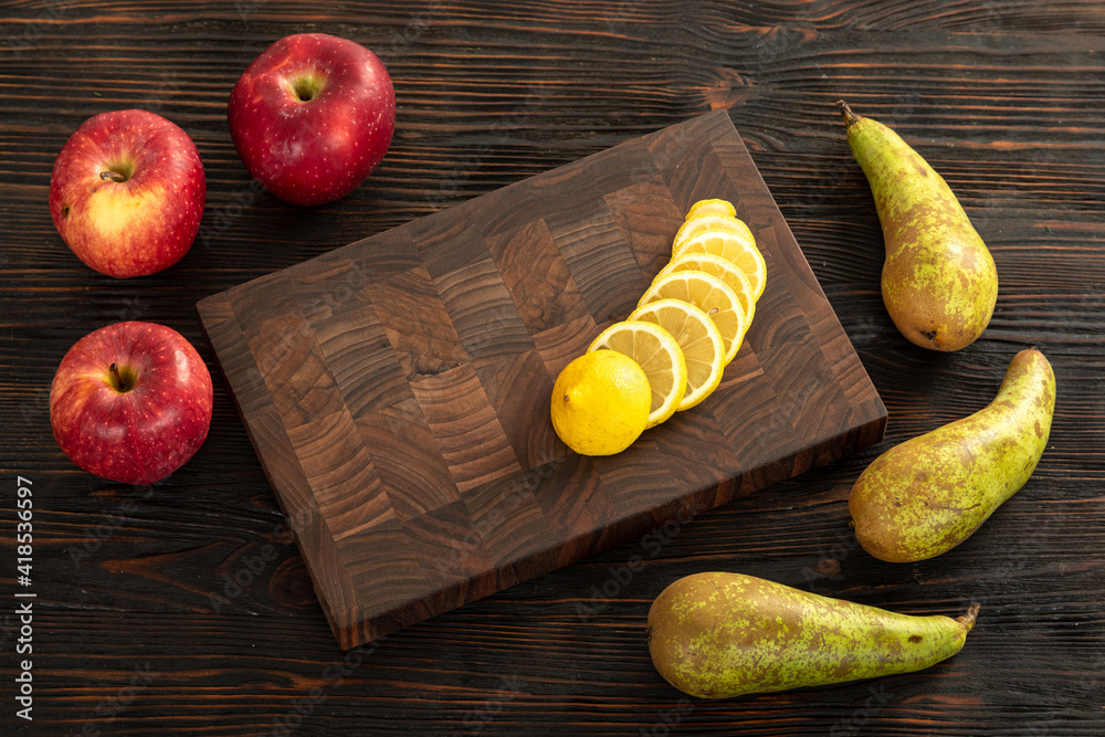 Fresh sliced lemon on a wooden cutting board