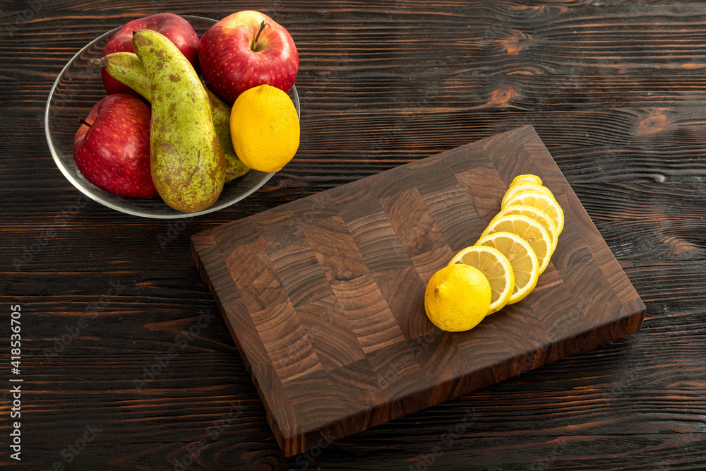 Fresh sliced lemon on a wooden cutting board