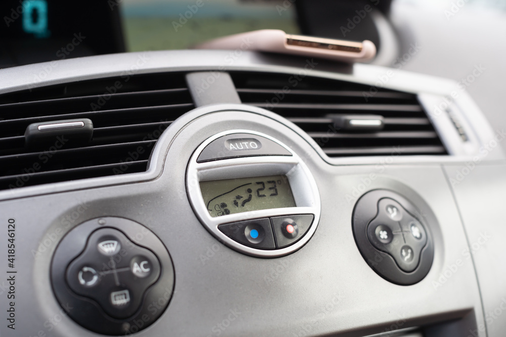 Dashboard in a passenger car. Heating and air conditioning control buttons. Dashboard in a passenger car. Heating and air conditioning control buttons.