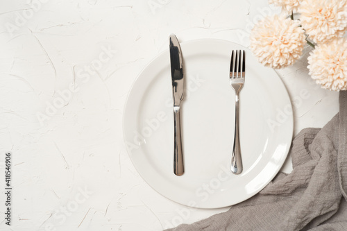food concept stylish table setting cutlery on white table with silver fork and knife. top view or flat lay                         