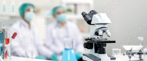 microscope and scientific equipment Blur the background as Two chemists sit in a chemistry lab