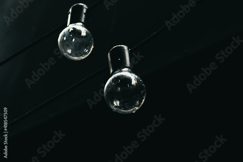 Two light bulbs on black background