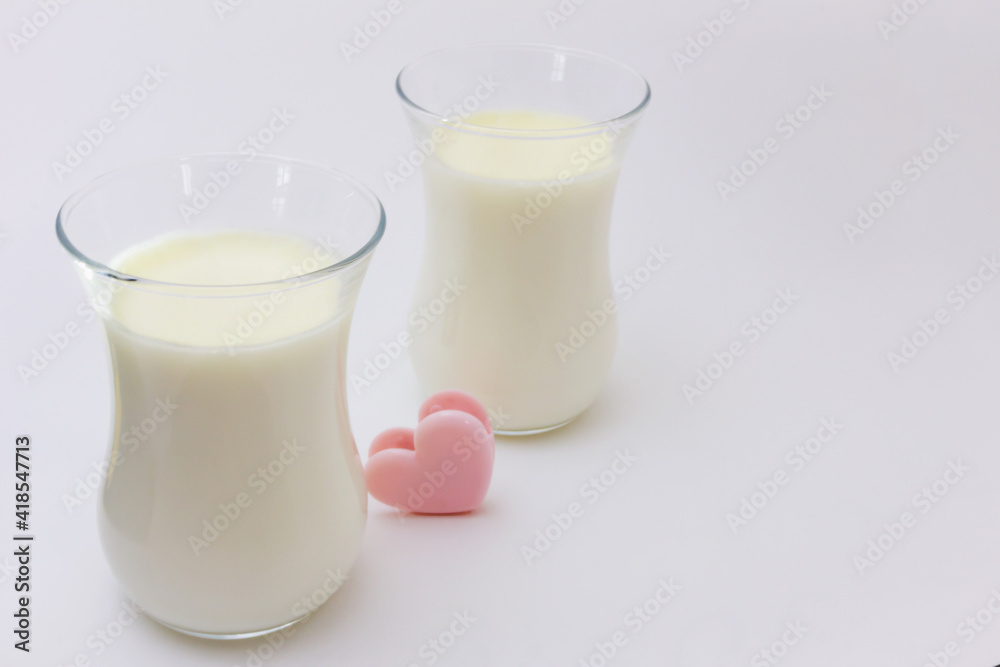 Two transparent glasses with white creamy Italian dessert Panna Cotta on a light background. Two transparent glasses with white creamy Italian dessert Panna Cotta on a light background.
