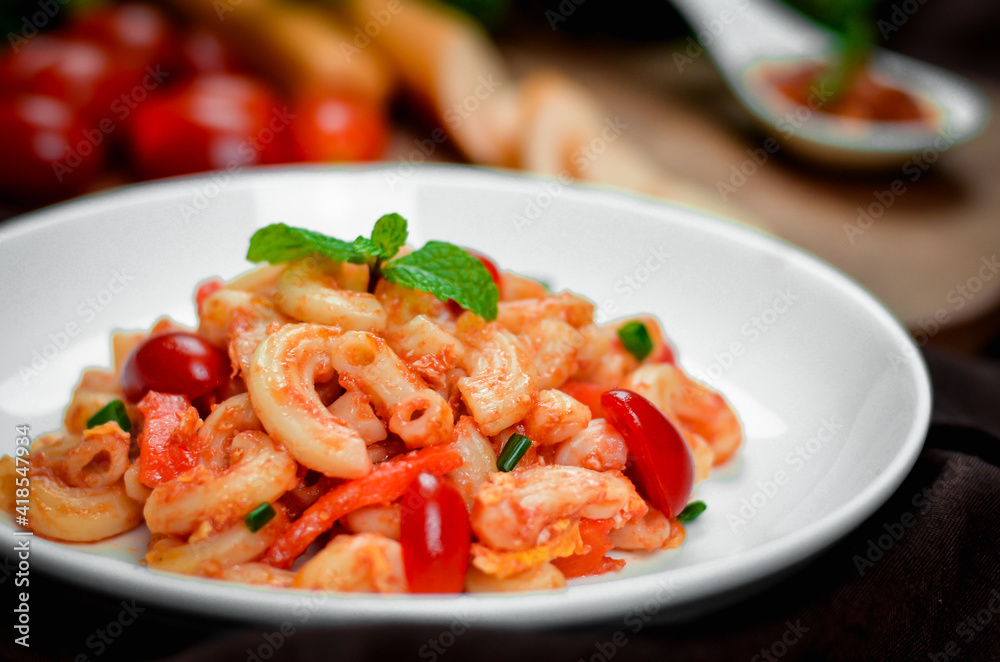 Pasta with spicy tomato sauce and basil and sausage. Pasta with spicy tomato sauce and basil and sausage.