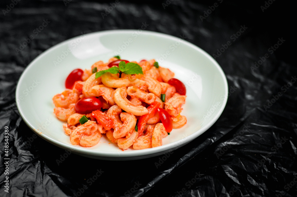 Pasta with spicy tomato sauce and basil and sausage. Pasta with spicy tomato sauce and basil and sausage.