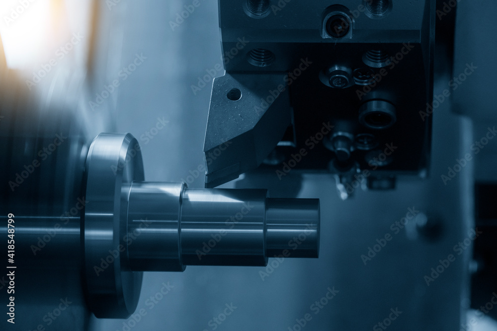 The  CNC lathe machine cutting the metal cone shape parts. The hi-technology metal working processing by CNC turning machine .